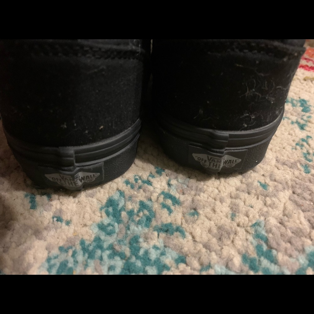 Black hi-top vans.